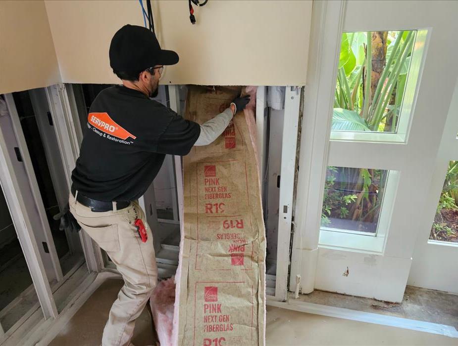 SERVPRO technician removing insulation due to water damage