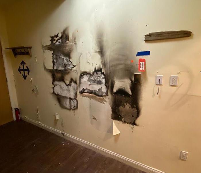 fire damage on wall, smoke and soot damage show in abundance
